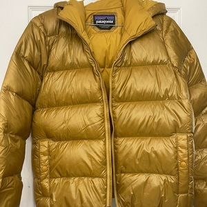 Gold Patagonia puffer coat with hood.